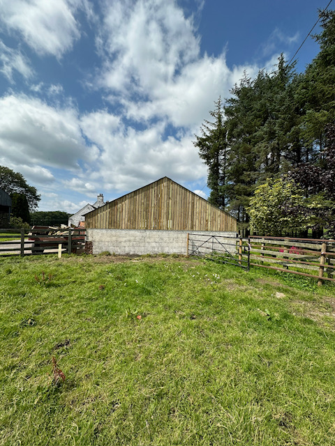 Completed barn cladding project with natural timber finish