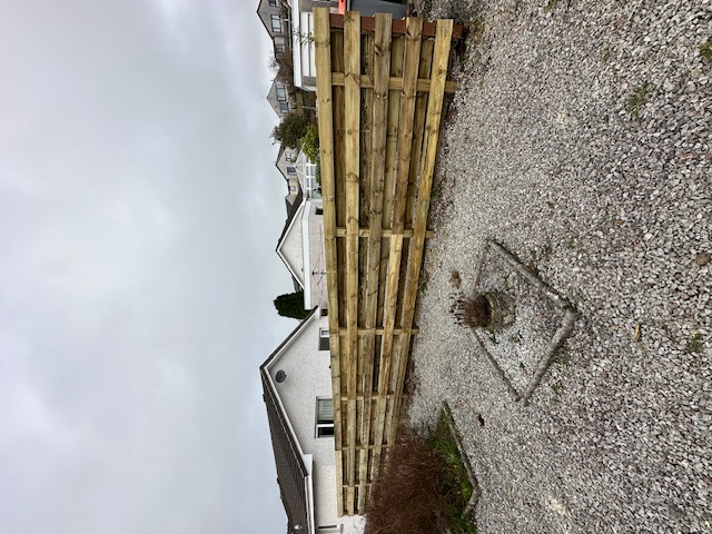 Horizontal timber fence installation in residential area