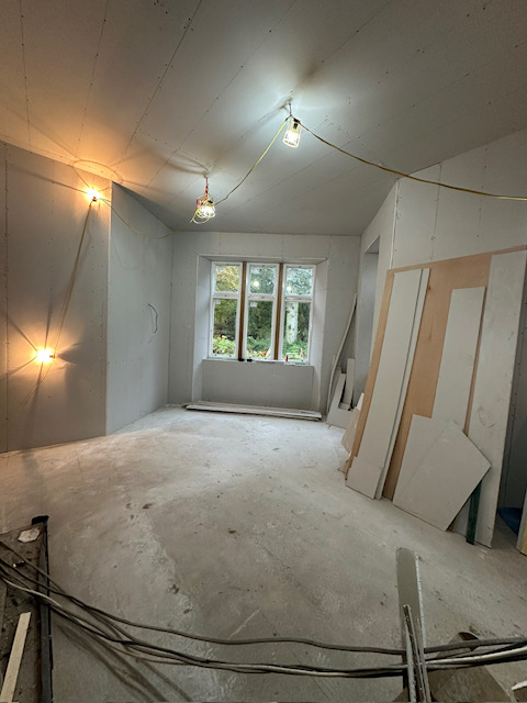 Loft conversion renovation in progress with vaulted ceiling