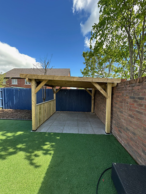Garden pergola structure over artificial grass and paved patio