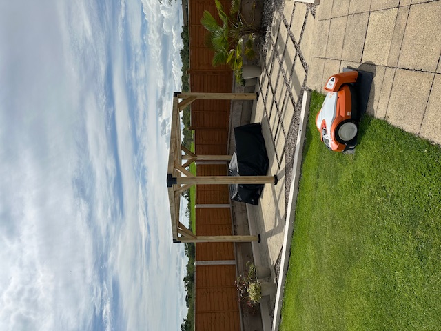 Custom timber pergola over garden patio with seating area