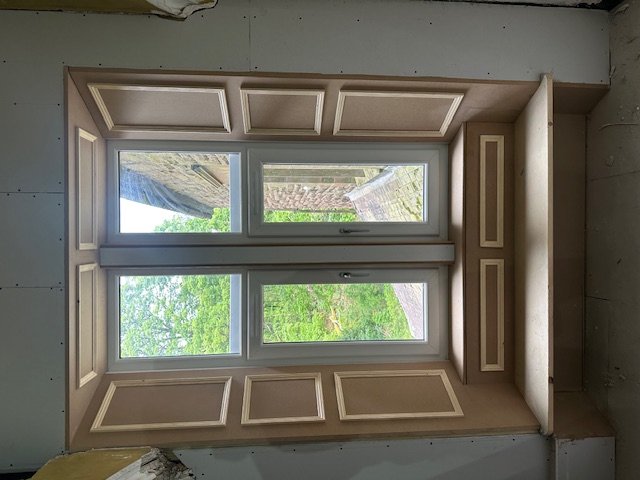 Custom window seat with built-in storage and shutters